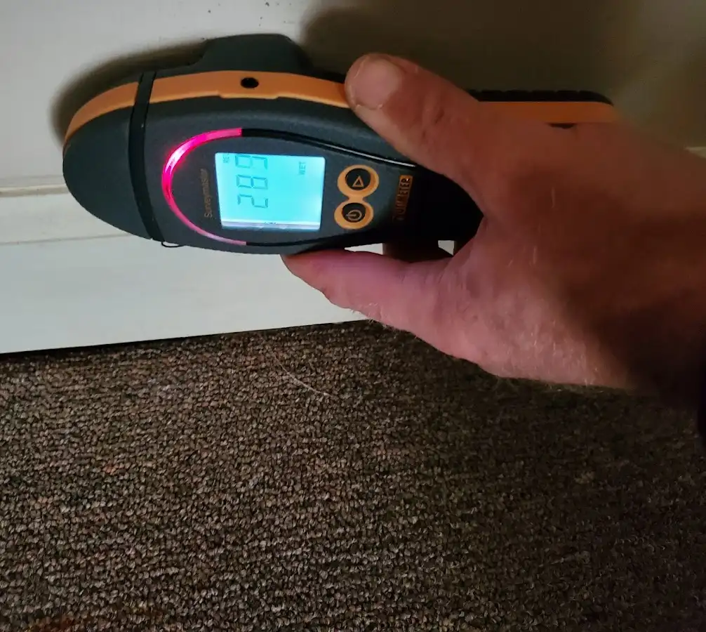 Moisture detection at baseboard during Storm Damage Restoration in Marengo